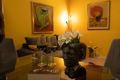 a table with wine glasses and a bust of a head at ArtE Vitosha Blvd in Sofia