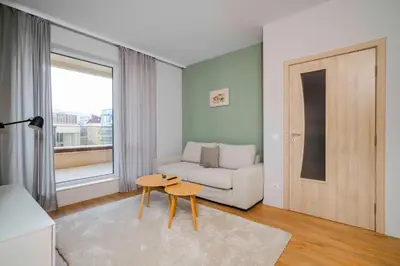 a living room with a couch and a table at Modern and Central 1BD Flat with Balcony by Flat Mаnager in Sofia