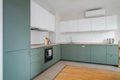 a kitchen with blue cabinets and white appliances at Modern and Central 1BD Flat with Balcony by Flat Mаnager in Sofia