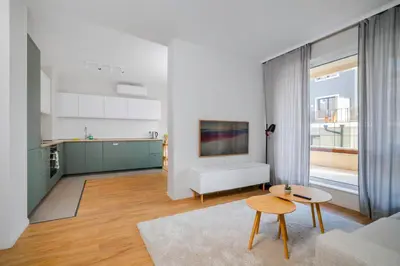 a living room with a couch and a table at Modern and Central 1BD Flat with Balcony by Flat Mаnager in Sofia