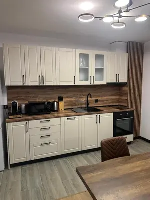 a kitchen with white cabinets and a sink at MonarX Suites in Bansko