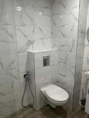 a white bathroom with a toilet and a sink at MonarX Suites in Bansko
