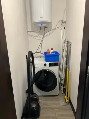 a washing machine sitting in a room with aperature at MonarX Suites in Bansko