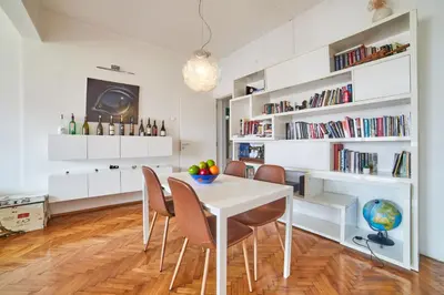a dining room with a white table and chairs at Main Street Sunshine 2 KING Bdr in Sofia