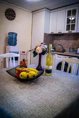 a table with a plate of fruit and a bottle of wine at NIKI Apart in Sofia