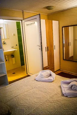 a bedroom with a bed with two towels on it at NIKI Apart in Sofia