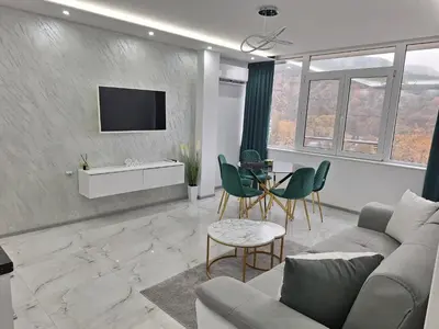 a living room with a couch and a table at Sandanski park view in Sandanski