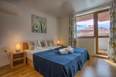 a bedroom with a bed and a large window at Cedar Lodge 2 Bedroom Apartment by Flat Mаnager in Bansko