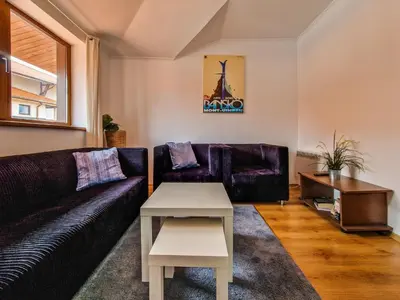 a living room with a couch and a table at Cedar Lodge 2 Bedroom Apartment by Flat Mаnager in Bansko