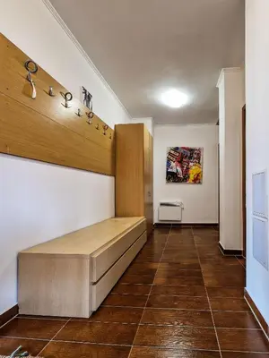 a room with a bench on the wall and a painting at Cedar Lodge 2 Bedroom Apartment by Flat Mаnager in Bansko