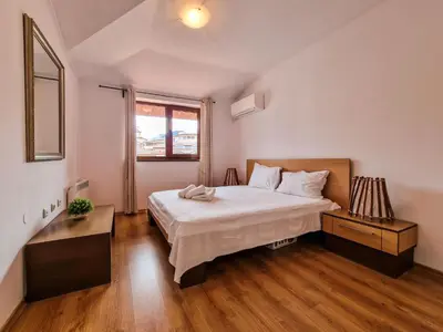 a bedroom with a large white bed and a window at Cedar Lodge 2 Bedroom Apartment by Flat Mаnager in Bansko