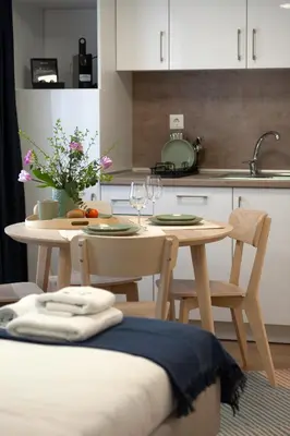 a kitchen with a table with two chairs and a table with wine glasses at Ruby Red House in Sofia
