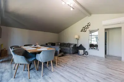 a dining room with a table and chairs and a couch at Alexandra Family Estate in Samoranovo