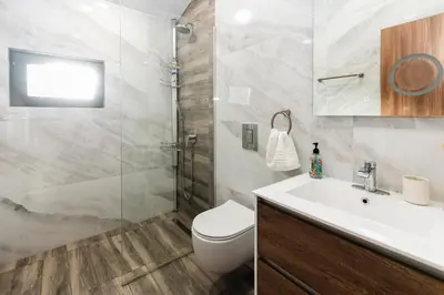 a bathroom with a toilet and a sink and a shower at Alexandra Family Estate in Samoranovo