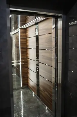 a glass door of a closet with wooden panels at ТОП Апартаменти в Панорама Парк in Plovdiv