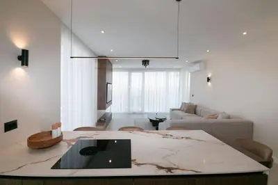 a living room with a couch and a table at Cozy Elegant 2BR Apt + Free Parking next to Paradise Mall in Sofia