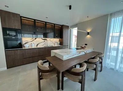 a kitchen with a wooden table and some chairs at Cozy Elegant 2BR Apt + Free Parking next to Paradise Mall in Sofia