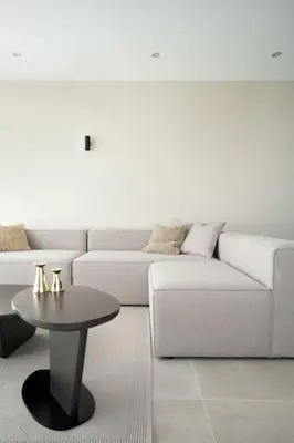 a living room with a white couch and a table at Cozy Elegant 2BR Apt + Free Parking next to Paradise Mall in Sofia