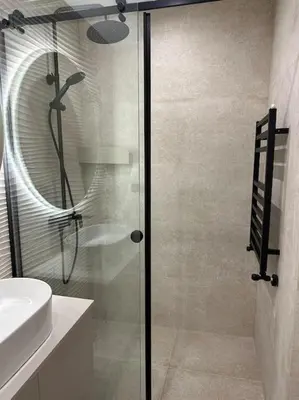 a glass shower in a bathroom with a sink at Cozy Elegant 2BR Apt + Free Parking next to Paradise Mall in Sofia