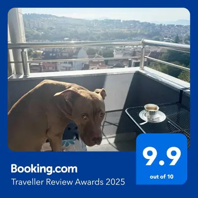 a brown dog standing on a balcony with a table at VANITY Apartments in Sandanski