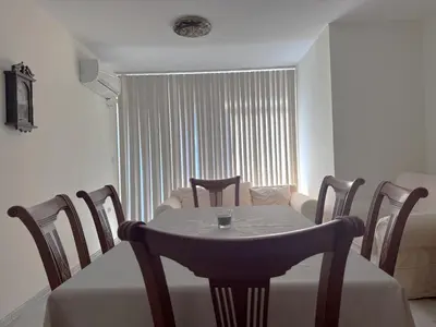 a dining room with a table and chairs and a living room at VANITY Apartments in Sandanski