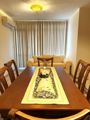 a dining room table with a cake on top of it at VANITY Apartments in Sandanski