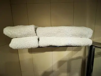 two white towels sitting on a shelf in a bathroom at VANITY Apartments in Sandanski