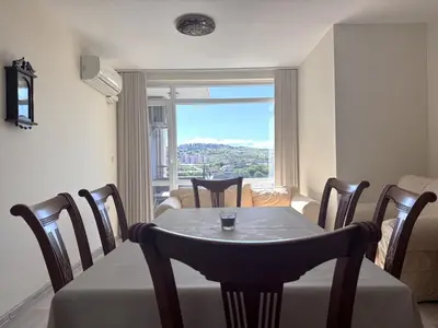 a dining room with a table and chairs and a window at VANITY Apartments in Sandanski