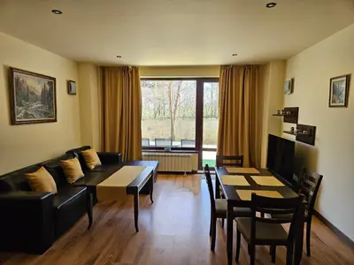 a living room with a couch and a table at TERRA COMPLEX D5 - Private apartment - Golf, Skiing & SPA in Razlog