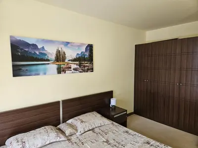 a bedroom with a bed and a painting on the wall at TERRA COMPLEX D5 - Private apartment - Golf, Skiing & SPA in Razlog