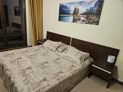 a bedroom with a bed and a picture on the wall at TERRA COMPLEX D5 - Private apartment - Golf, Skiing & SPA in Razlog