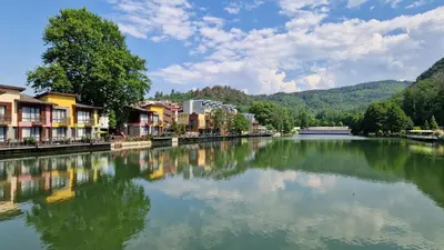 a river in a town with houses and buildings at Waterside SPA Hotel in Ognyanovo