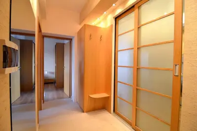 a walk in closet with glass doors and a hallway at Vitosha Sunrise in Sofia