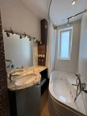 a bathroom with two sinks and a tub and a large mirror at Vitosha Sunrise in Sofia