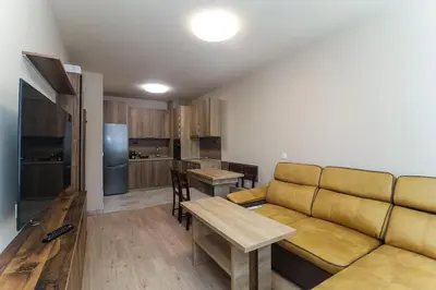a living room with a couch and a kitchen at Cherkovna Residence Apartment plus GARAGE !!! in Sofia
