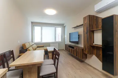 a living room with a dining table and a television at Cherkovna Residence Apartment plus GARAGE !!! in Sofia