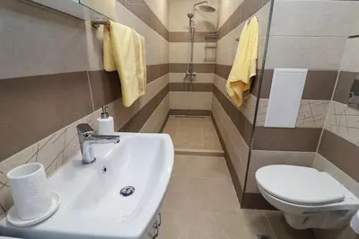 a bathroom with a sink and a toilet at Cherkovna Residence Apartment plus GARAGE !!! in Sofia
