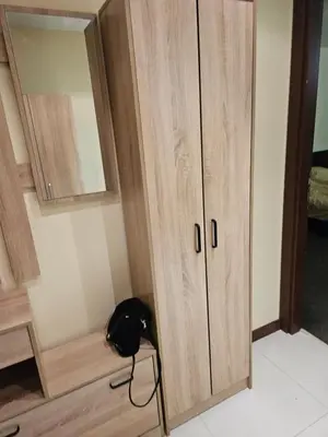 a wooden cabinet with a black bag sitting next to it at TERRA COMPLEX B4 - Private apartment - Golf, Skiing & SPA in Bansko