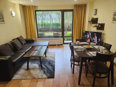 a living room with a couch and a table at TERRA COMPLEX B4 - Private apartment - Golf, Skiing & SPA in Bansko