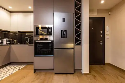 a kitchen with stainless steel appliances in a room at Central Victoria Home 2-bedroom apt in Plovdiv