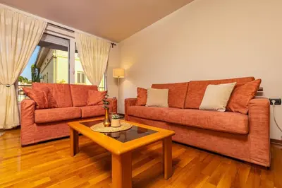 a living room with a couch and a coffee table at La Primavera Spacious Apartment in Plovdiv