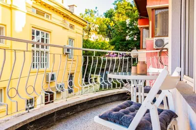 a balcony with a table and chairs on a building at La Primavera Spacious Apartment in Plovdiv