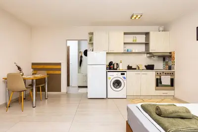 a kitchen with a washer and dryer in a room at Studio 'Ozi' quite place in Perfect Center in Plovdiv