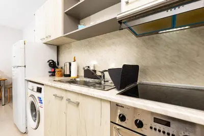 a kitchen with a sink and a laptop on the counter at Studio 'Ozi' quite place in Perfect Center in Plovdiv