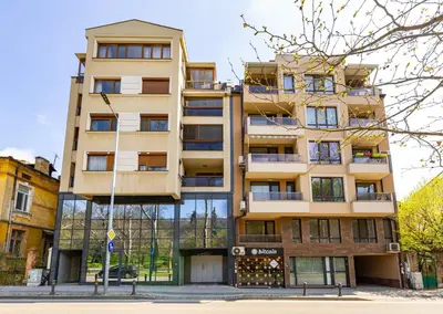 a tall building on a street in front of a building at Studio 'Ozi' quite place in Perfect Center in Plovdiv