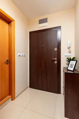 a brown door in a room with a white floor at Beautiful apartment in the heart of Plovdiv in Plovdiv
