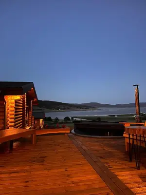 a wooden deck with a view of the water at Kare Luxury Chalets in Tsigov Chark