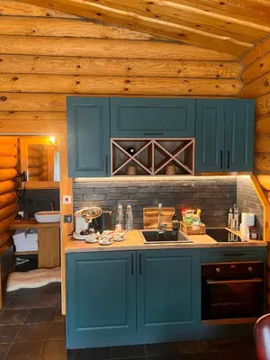 a kitchen with blue cabinets and a sink at Kare Luxury Chalets in Tsigov Chark