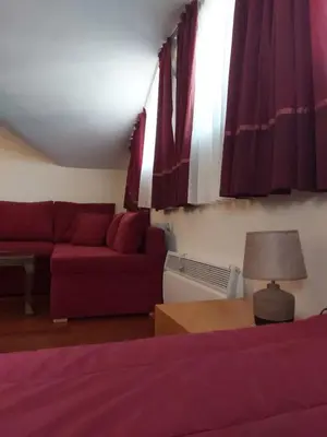 a living room with a bed and a couch at Апартамент-студио Б4-4-1 Божурленд in Bansko