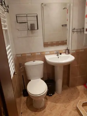 a bathroom with a toilet and a sink at Апартамент-студио Б4-4-1 Божурленд in Bansko